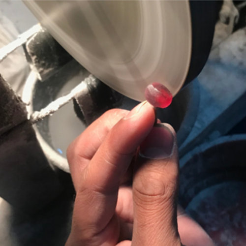 red rhodolite garnet being polished red rhodolite garnet being polished